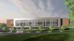 Architectural rendering of the new MUSC Health and Clemson University student medical and research facility in Clemson, S.C., showing a contemporary multi-story building set into a sloped landscape. The design combines large glass curtain walls framed in light gray cladding with warm wood-toned exterior volumes, including a cantilevered upper section, and a lower-level entrance integrated into the hillside. A curving drive, manicured lawn, and rows of young green trees shape the site around the building.